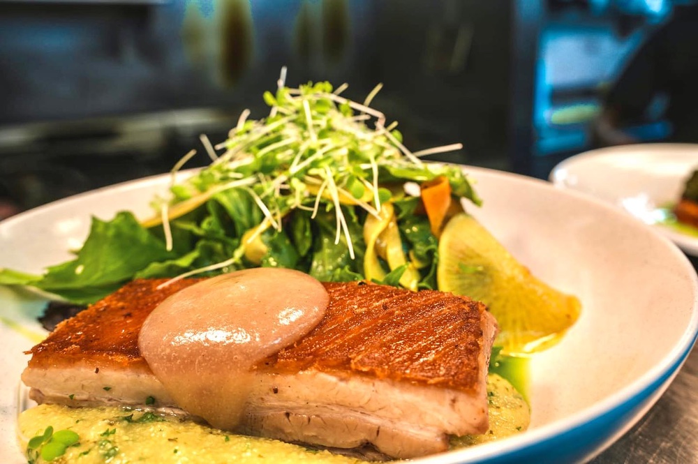 Pork Belly with smoked apple puree, polenta, pickled fennel mustard, and frisée salad